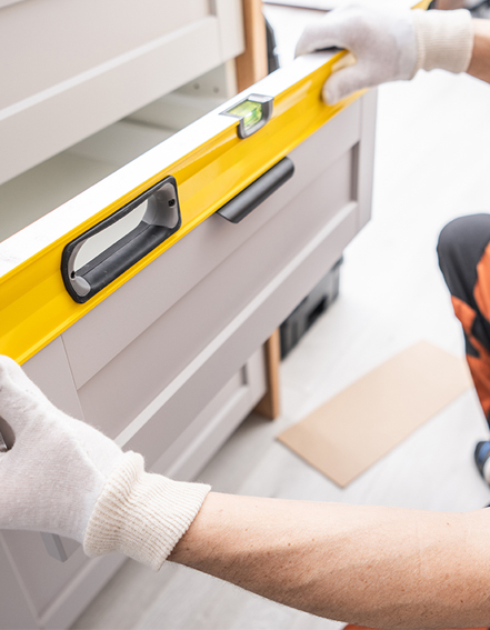 Cabinetmaker Fitting Kitchen Drawer and Checking Levels Virginia